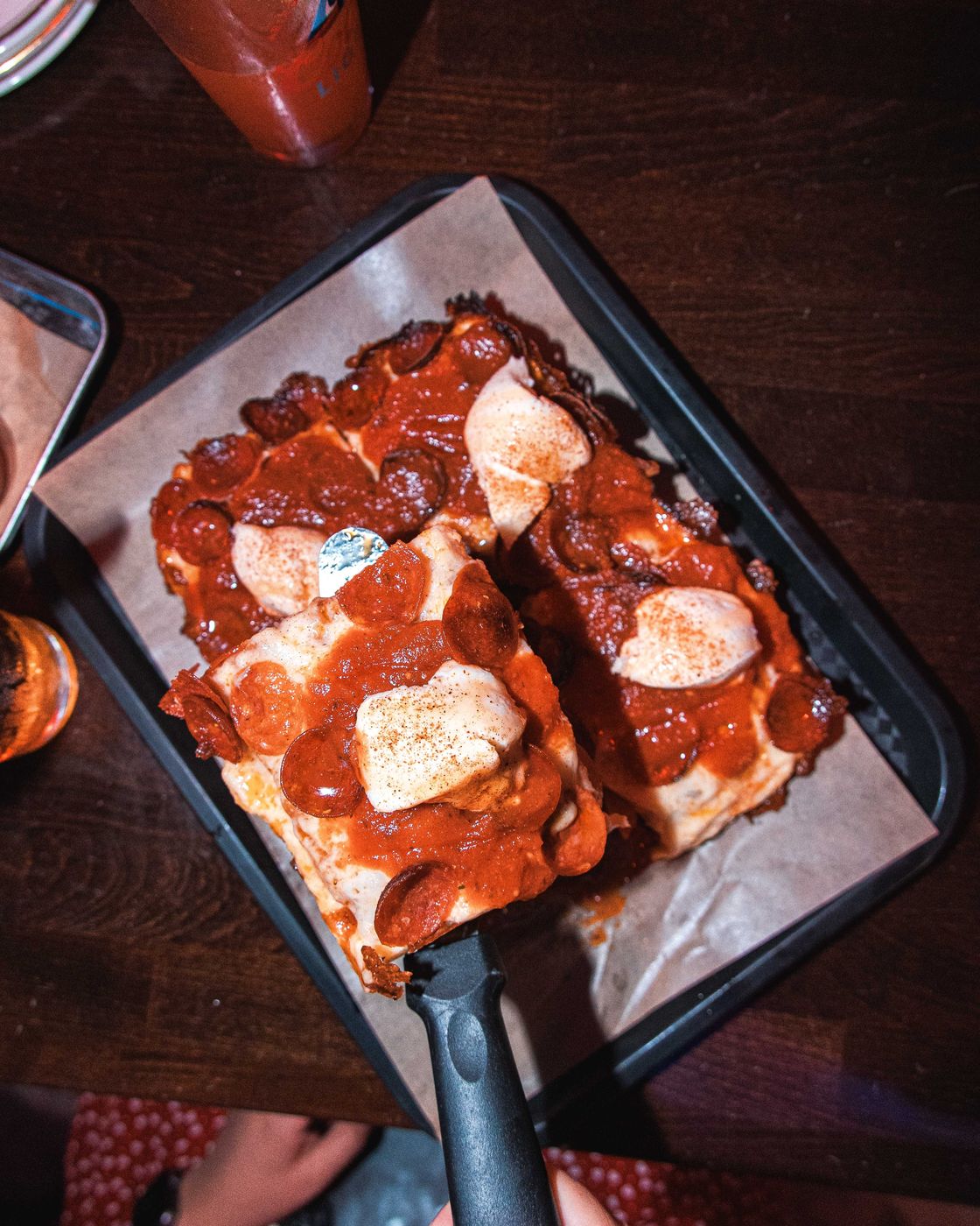 An overhead pepperoni Detroit pan on a tray