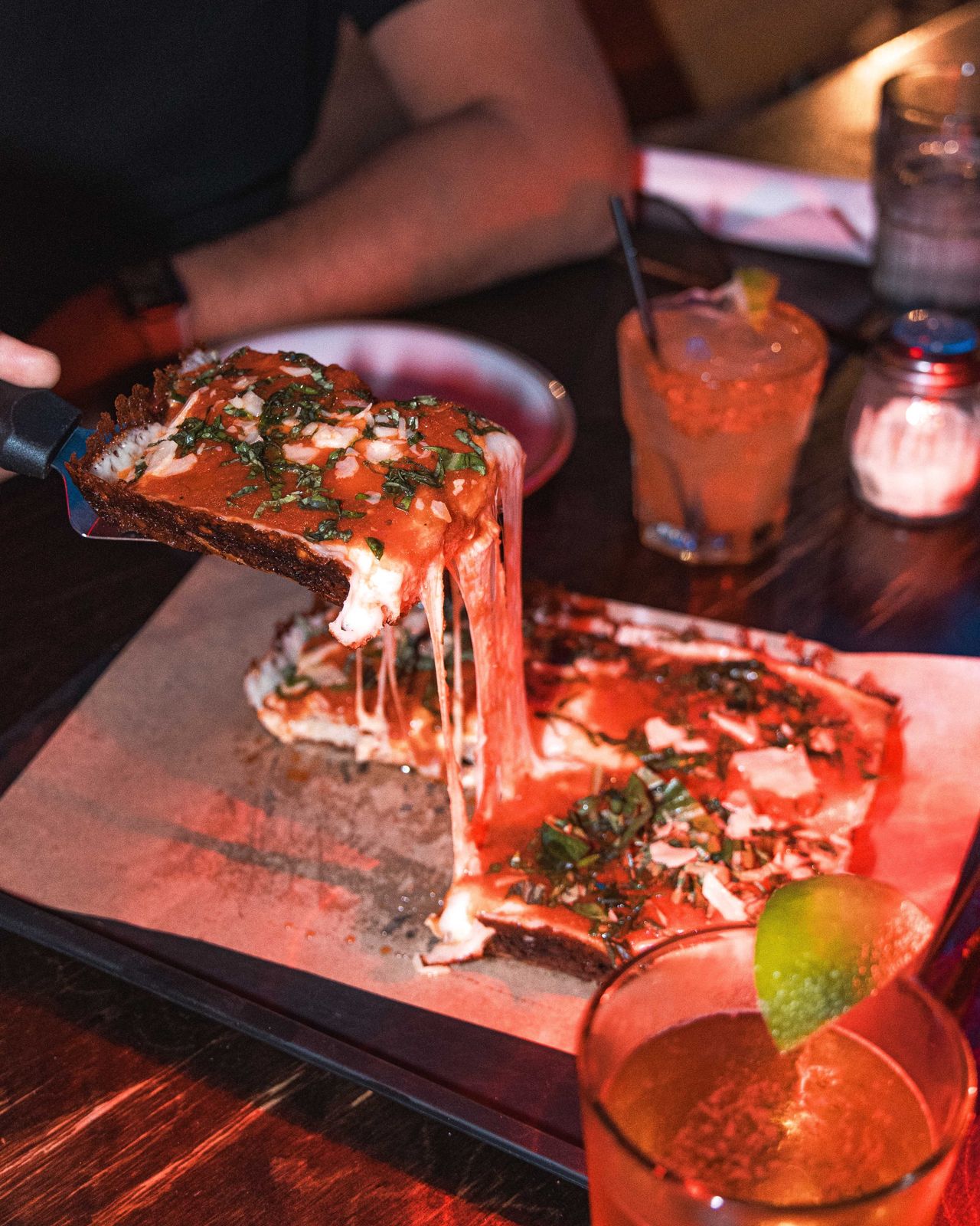 A cheese pull off a square Detroit pizza